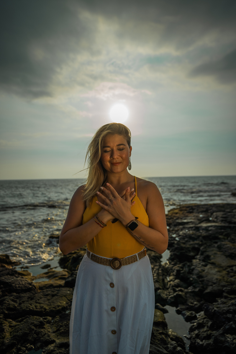 Calm woman meditating on beach